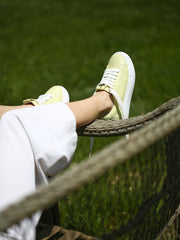 Lightweight white sole of pastel green sneakers, shown from below