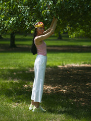 Pastel green sneakers styled with light summer outfit, outdoor setting