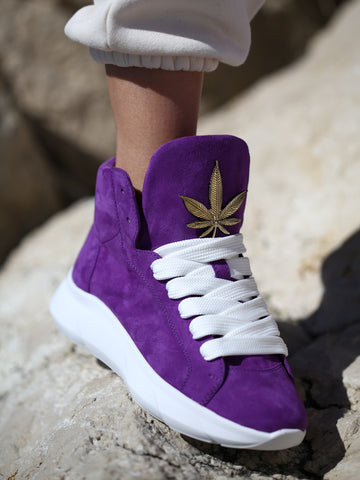 Purple suede sneakers with gold leaf accent, side view