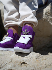 Handcrafted purple suede sneakers with gold detail on the tongue
